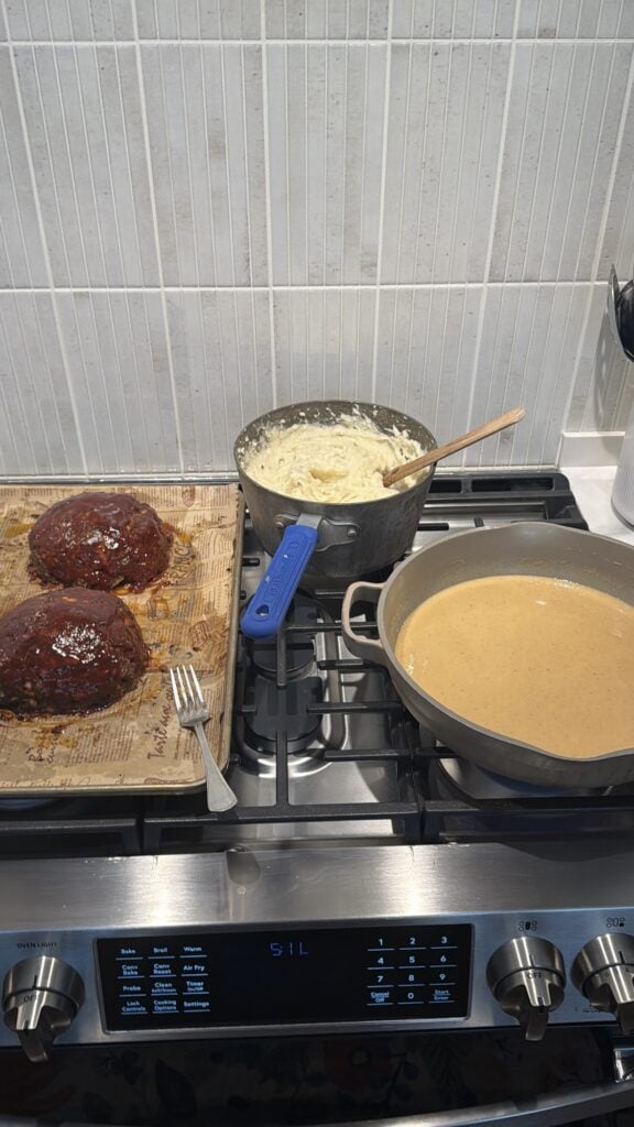 Meatloaf, mashed potatoes, and gravy on the stove