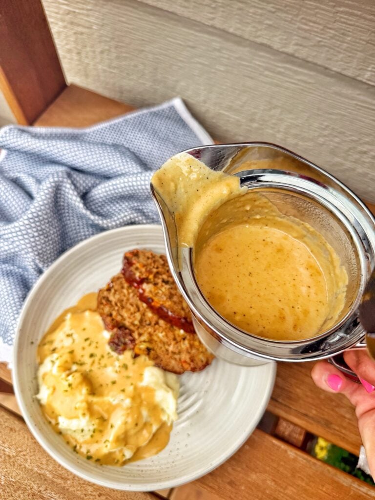 Gravy about to be poured over the meatloaf and potatoes