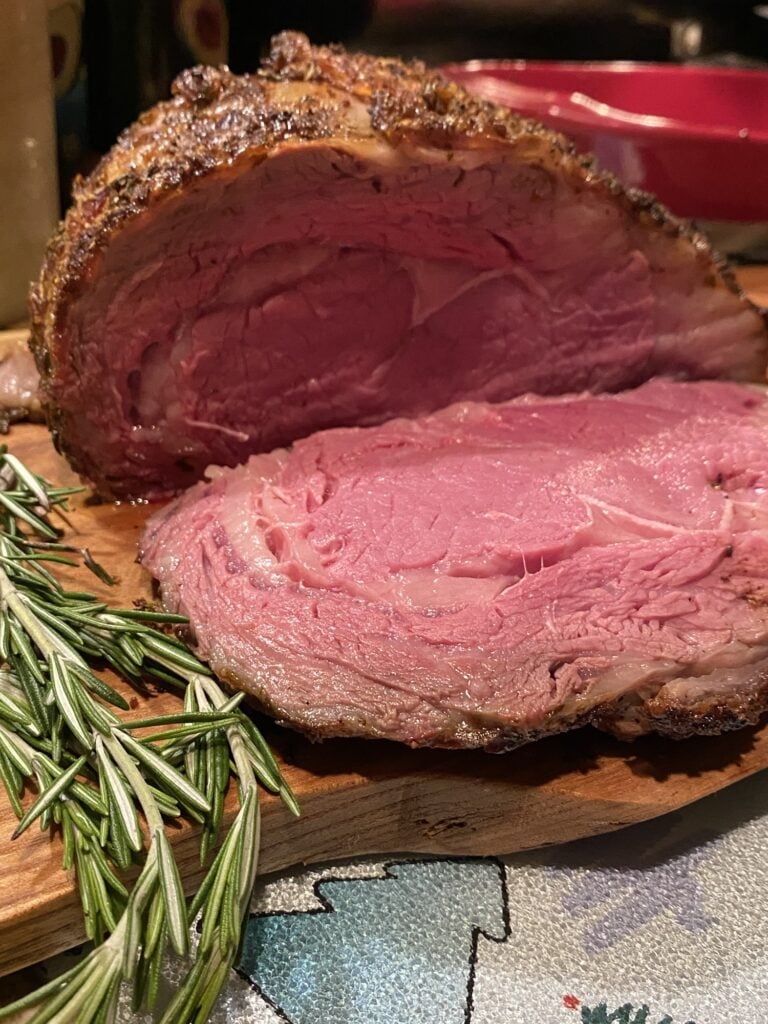 Perfect Rib Roast sliced and served with au jus for Christmas or a special holiday dinner.