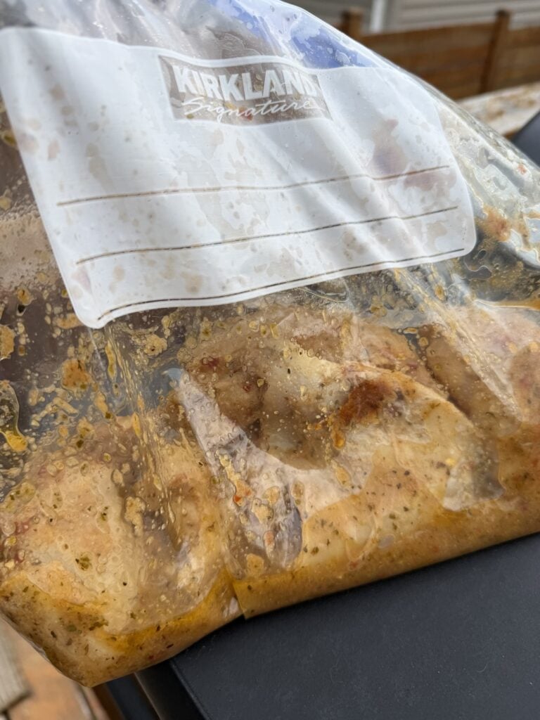 The chicken marinating in a zip top bag