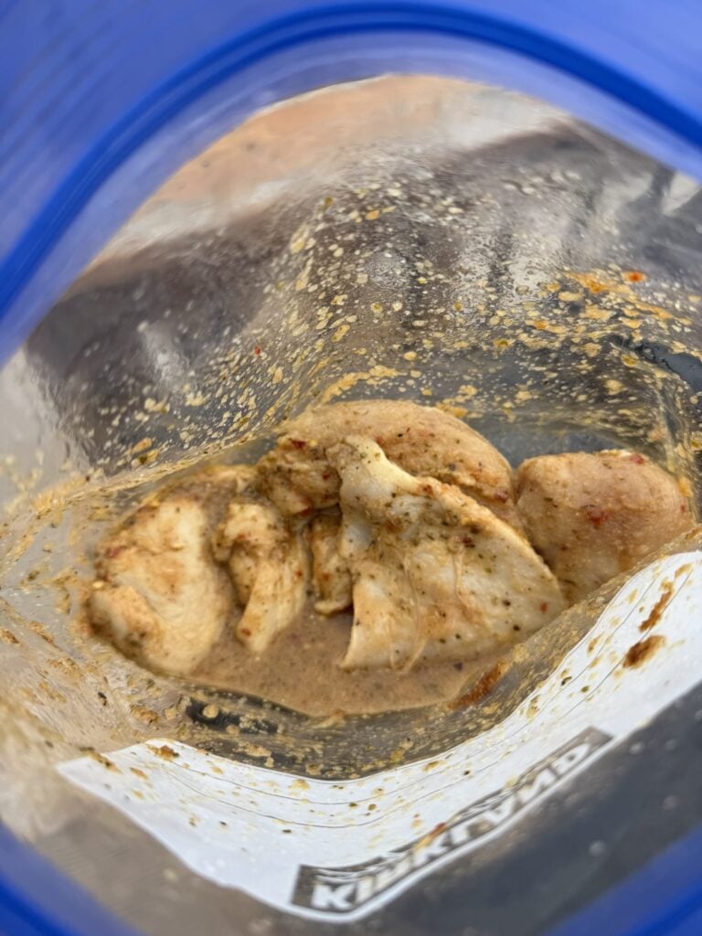 A peak into the marinating chicken in the freezer bag