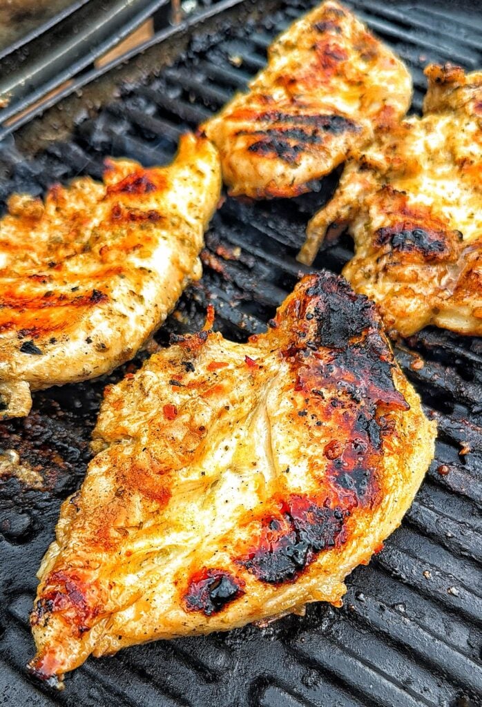 The chicken cooking on the grill