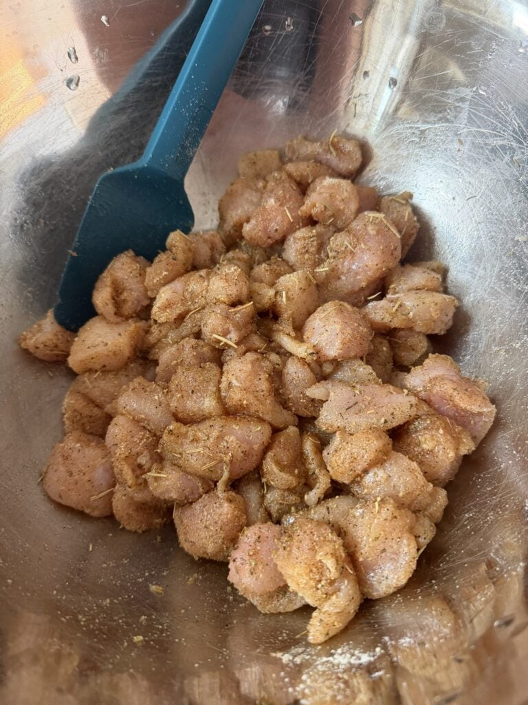 Raw bite-sized chicken tenderloin pieces seasoned for creamy chicken tortellini