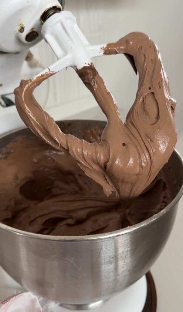 Doctored chocolate cake mix batter on the stand mixer attachment