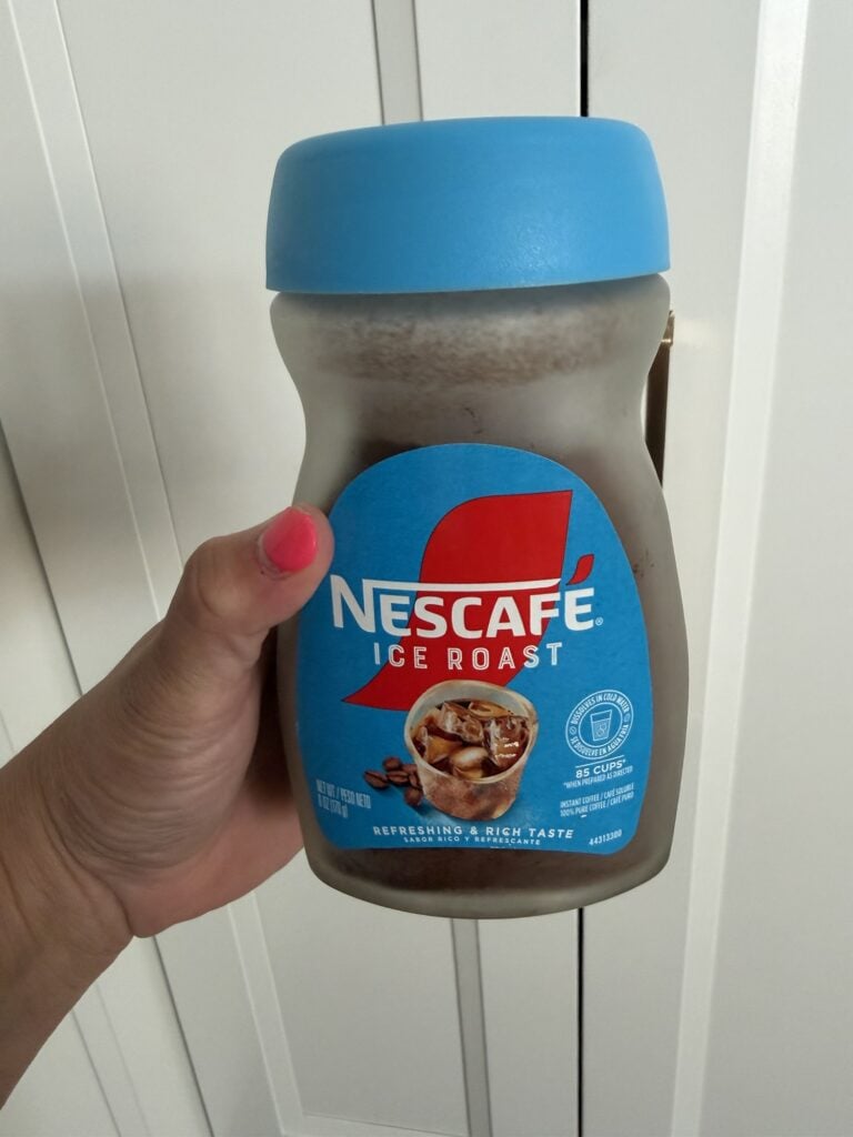A container of Nescafe Ice Roast instant coffee crystals