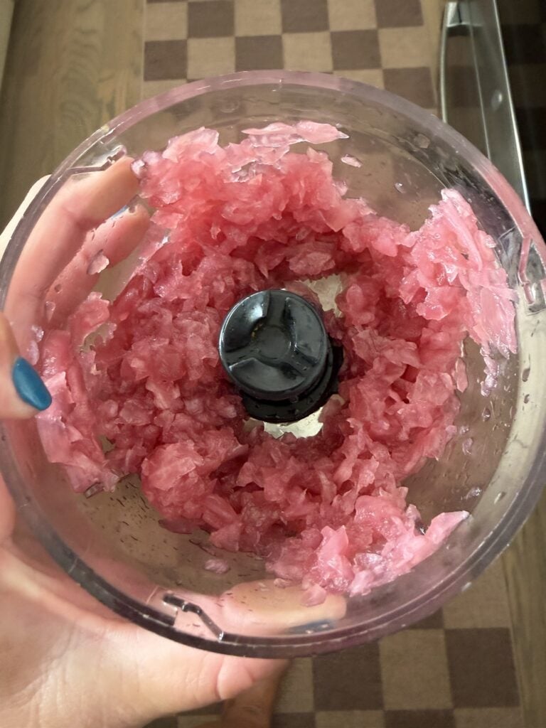 Marinated red onions finely minced in a food processor for creamy tuna pasta salad dressing
