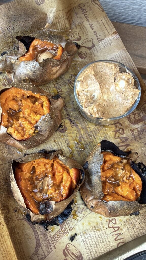 Split baked sweet potatoes with savory maple butter and toppings for Thanksgiving