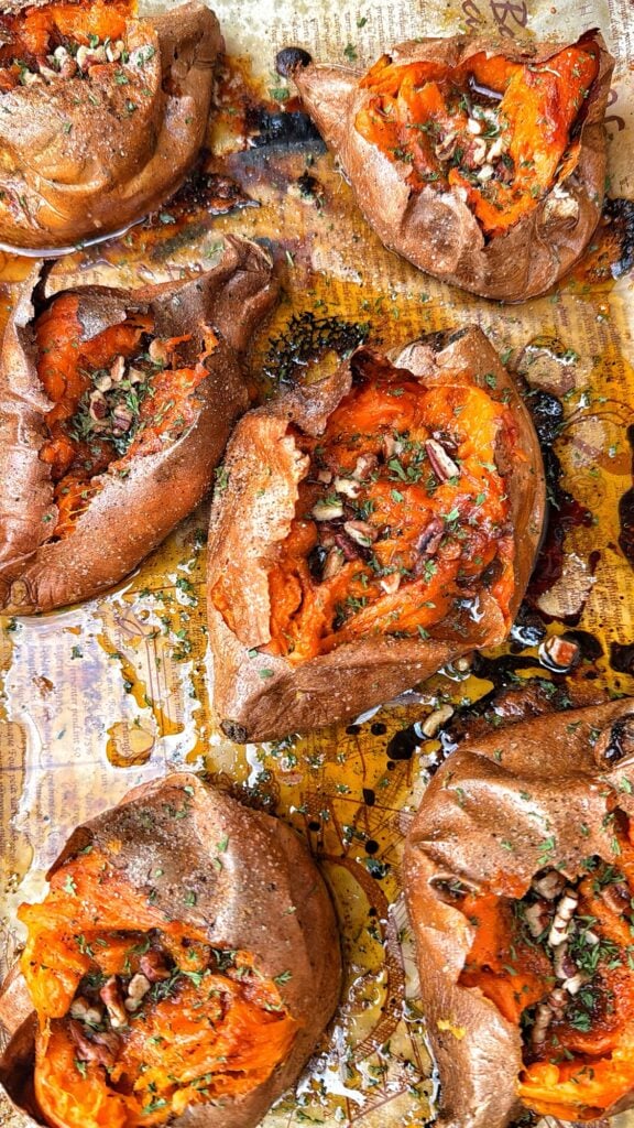 Ultimate baked sweet potatoes with savory maple butter, toasted pecans, and chives