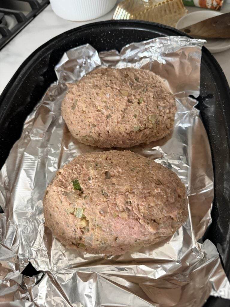 Uncooked Thanksgiving turkey meatloaf formed in a roasting pan before baking