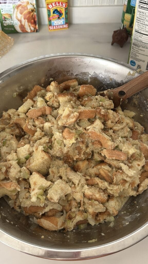 Correct wet consistency of Bell’s Seasoning stuffing before baking showing very moist bread without excess standing liquid.