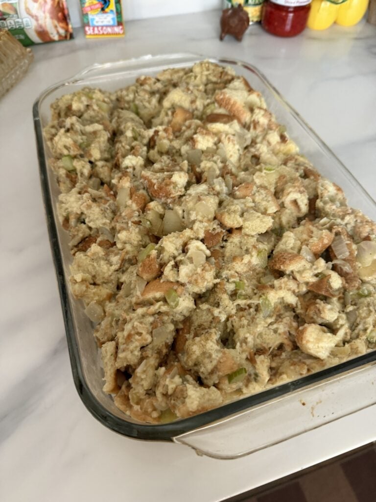 Bell’s Seasoning stuffing in a buttered 9 x 13 casserole topped with butter parsley and seasonings before baking.