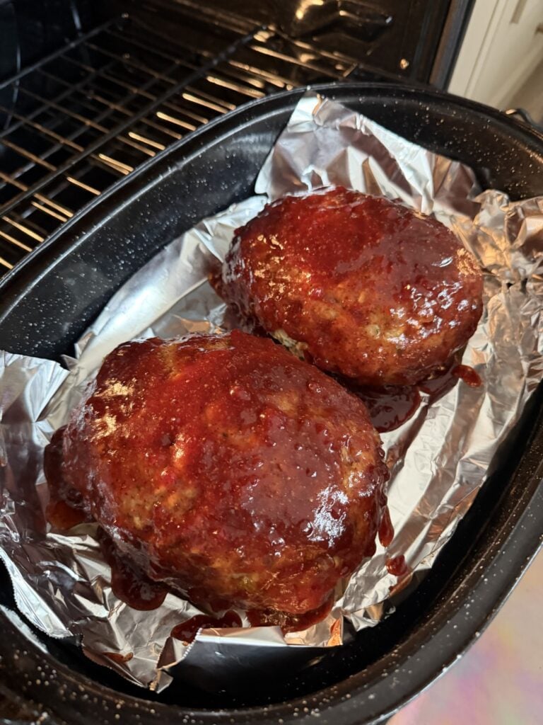 Thanksgiving turkey meatloaf brushed with glaze before finishing uncovered in the oven.