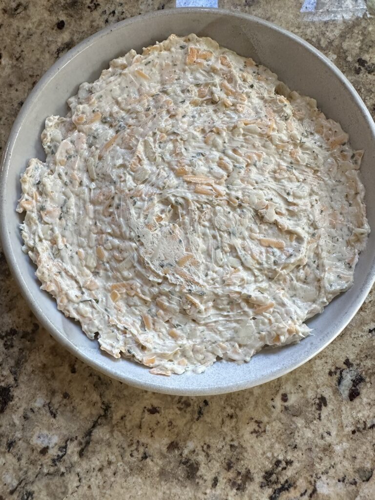 Creamy cheddar and pepper jack cheese dip chilled before adding pepper jelly.
