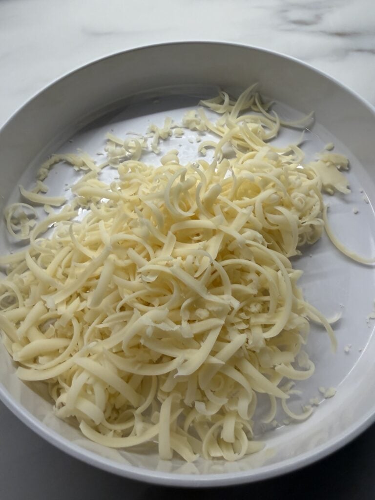 Freshly grated Swiss cheese for creamy chicken orzo bake
