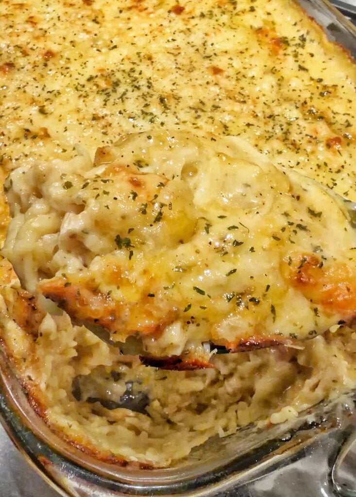A close up of Creamy chicken and orzo casserole with lemon and Swiss cheese