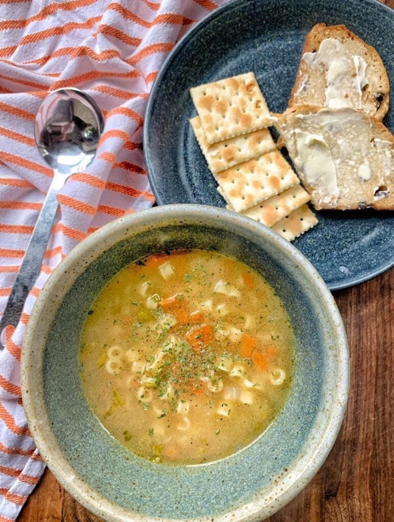chicken broth in a bowl with small noodles