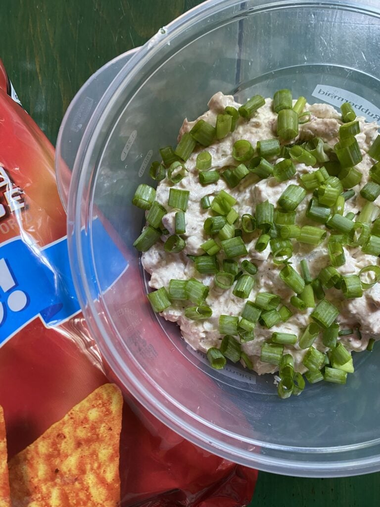Cold Dorito Chip Dip with bacon and green onions ready for a party