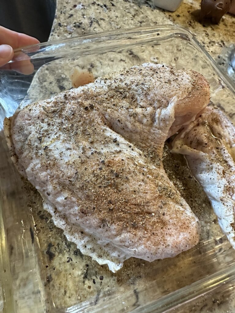 Seasoned turkey wings in a small roasting dish for homemade gravy