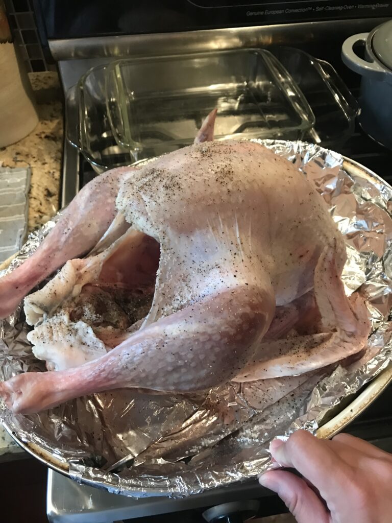 Raw Thanksgiving turkey seasoned and ready to rest uncovered overnight