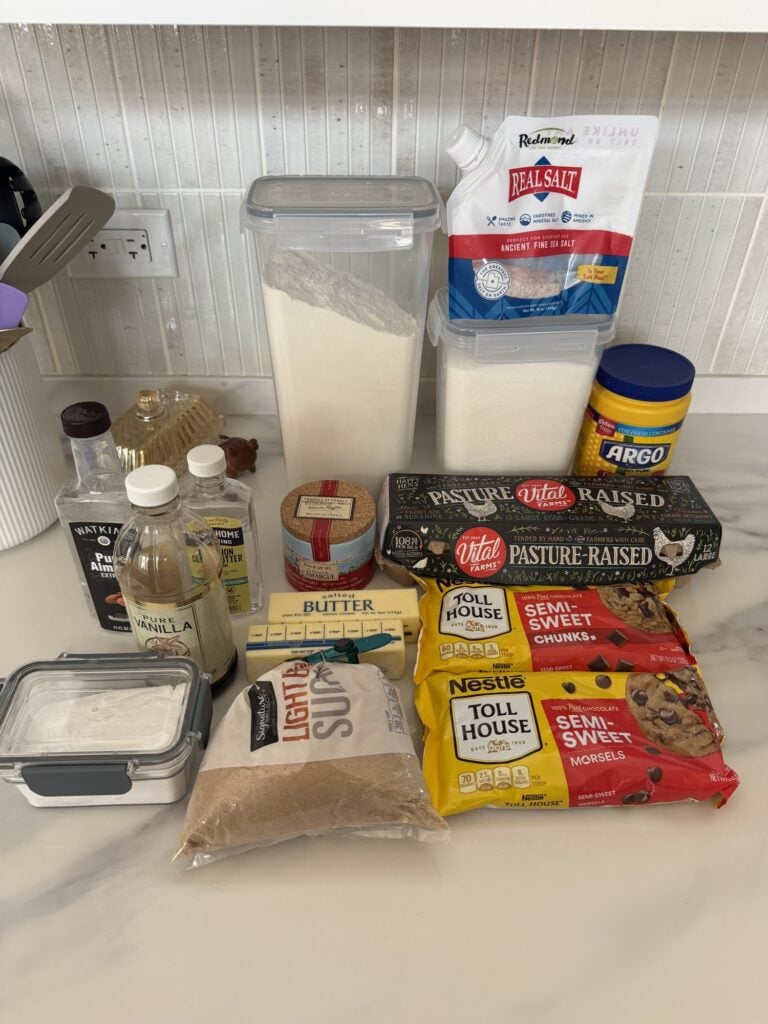 Ingredients for jumbo chocolate chip cookies including butter, brown sugar, eggs, chocolate chips, vanilla, almond and butter extracts.