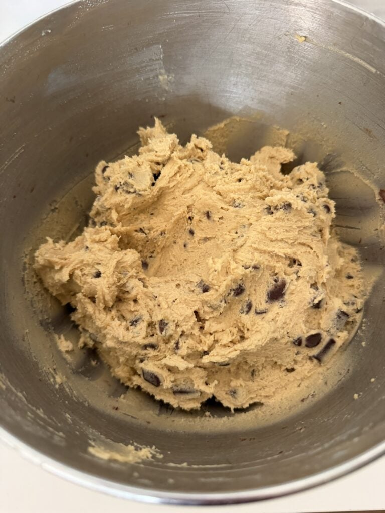 Homemade chocolate chip cookie dough filled with semi-sweet and milk chocolate before chilling.