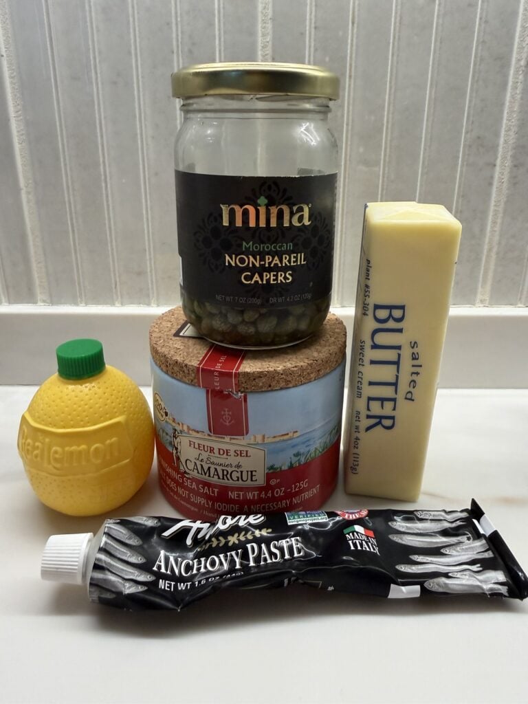 Ingredients for lemon anchovy butter with capers and Dijon mustard for roasted cauliflower.