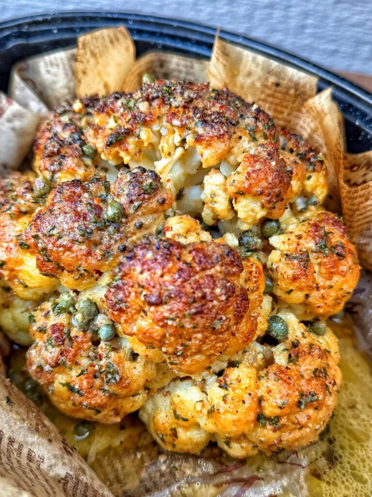 Tender roasted cauliflower with savory anchovy butter and capers.