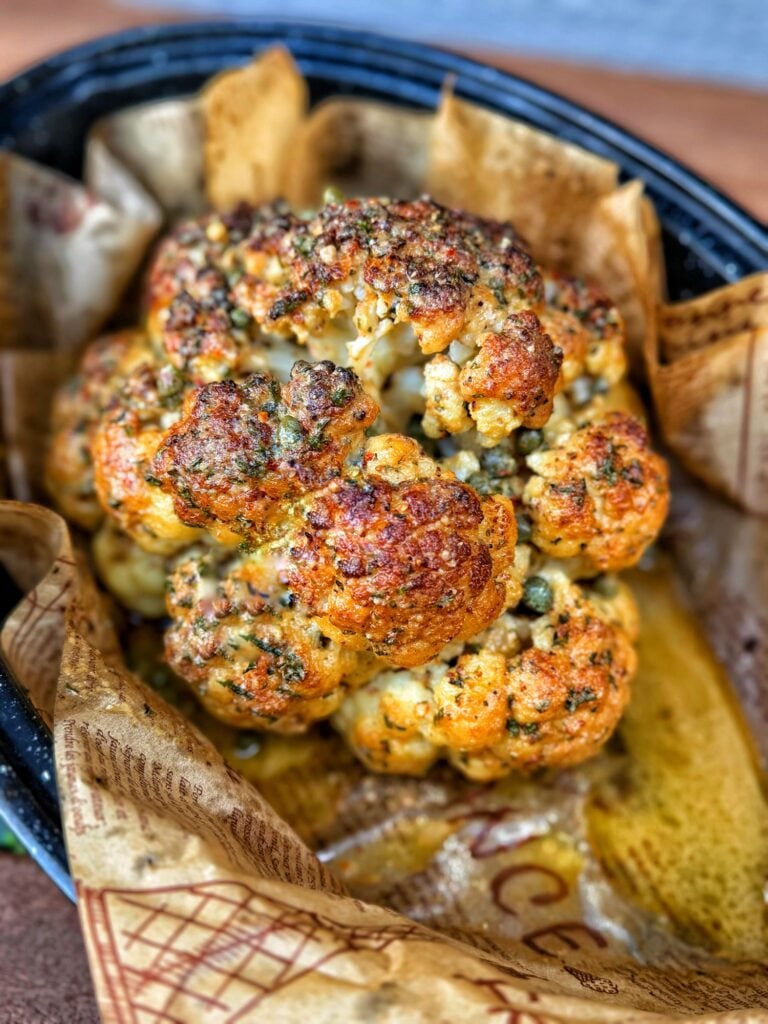 Retro whole roasted cauliflower with lemon anchovy butter, capers, and Dijon mustard.