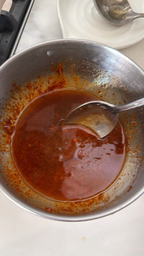 Spicy butter sauce with cayenne, sport pepper brine, and seasonings for Chicago hot chicken