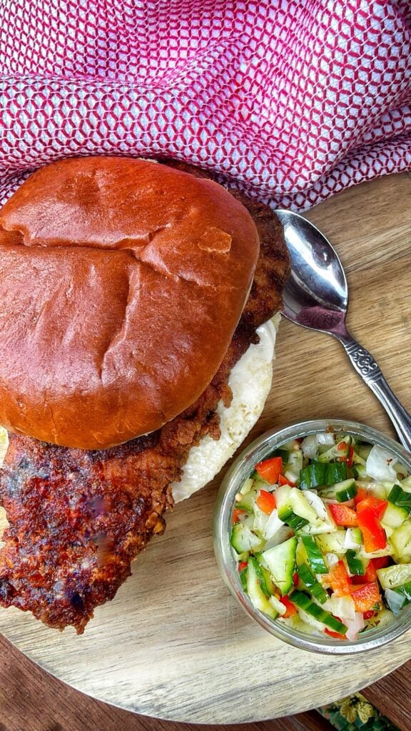 Crispy Chicago hot chicken sandwich topped with homemade cucumber and red pepper relish