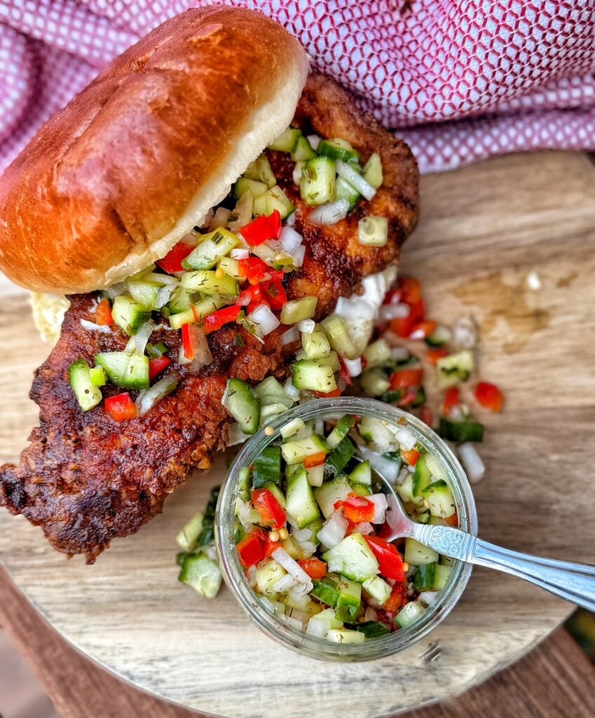 Spicy fried chicken sandwich served with fresh cucumber red pepper relish