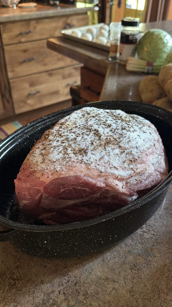 Seasoned raw pork shoulder roast used to make Mom’s low and slow pork roast.