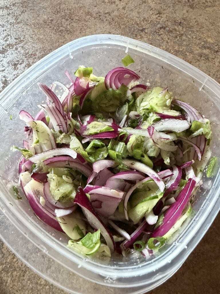 Thinly sliced cucumber and red onion marinated with rice vinegar dill and celery salt