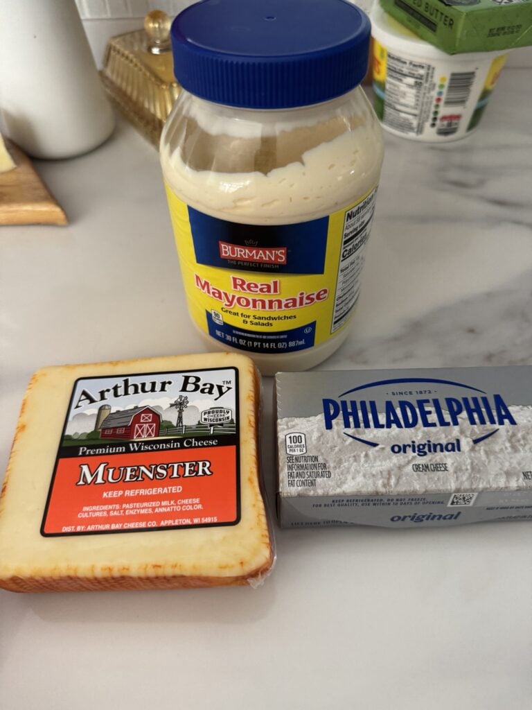 mayonaise, cream cheese and muenster cheese on a counter