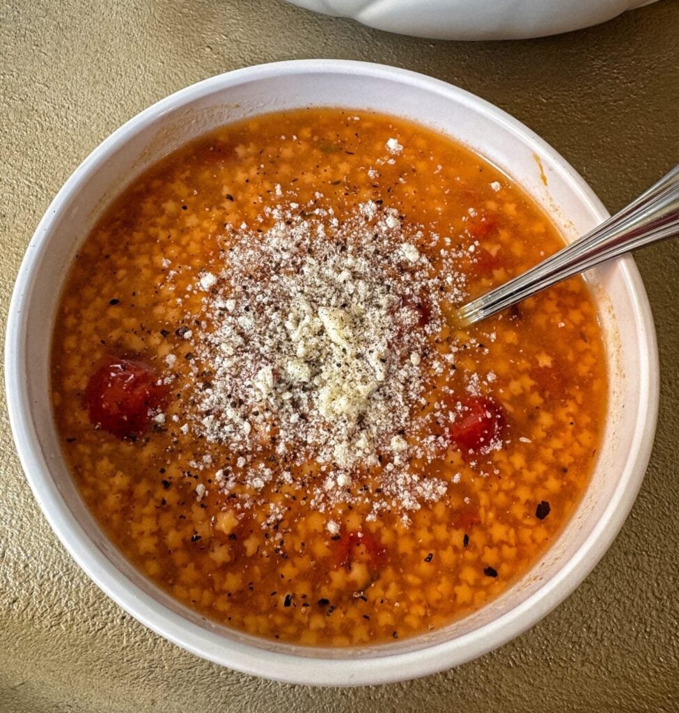 tomato soup with small pasta and parmesan cheese