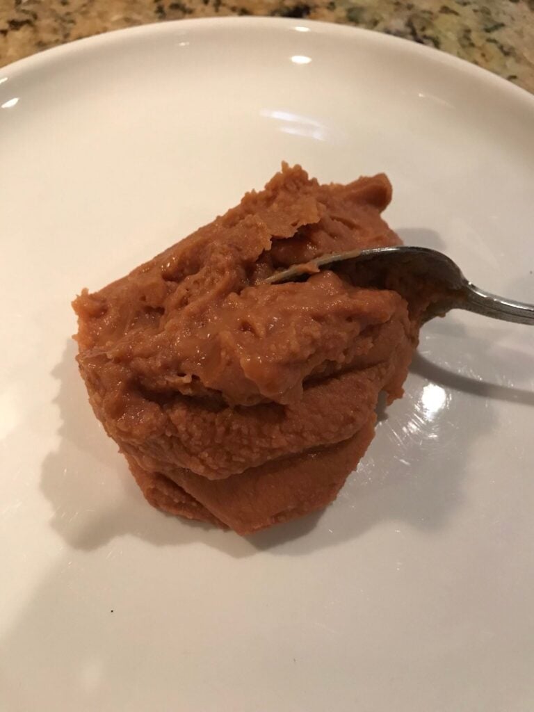bean dip being spooned on the plate