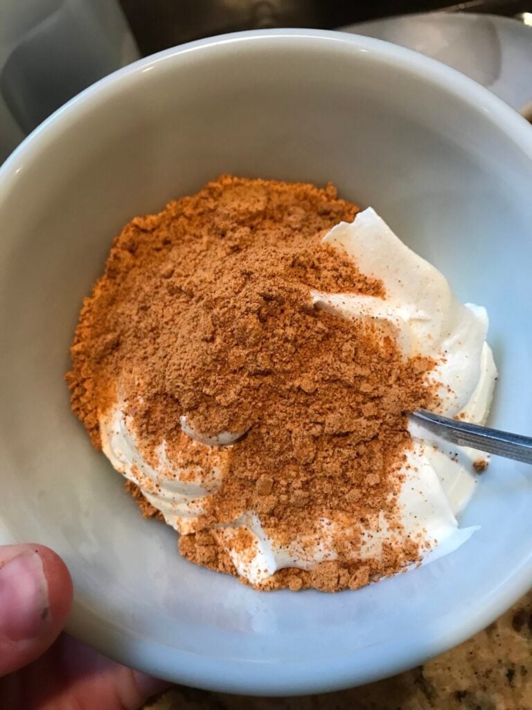 sour cream and taco seasoning being combined