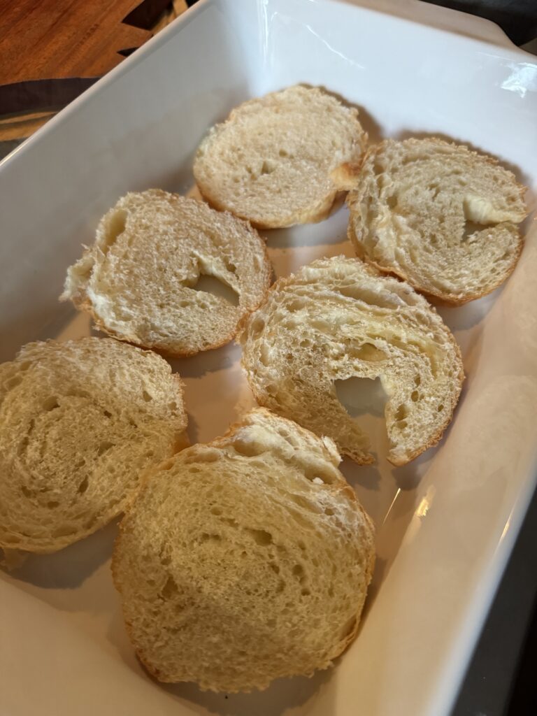 Sliced croissant bottoms in a baking dish used to make this recipe