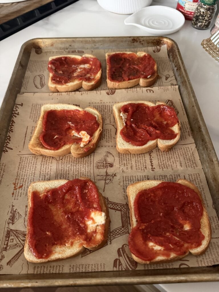 the white bread that is toasted with butter and pizza sauce.