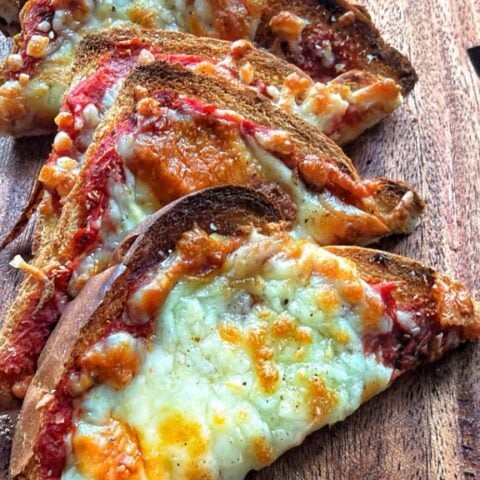 pizza toast triangle with melted mozzarella cheese