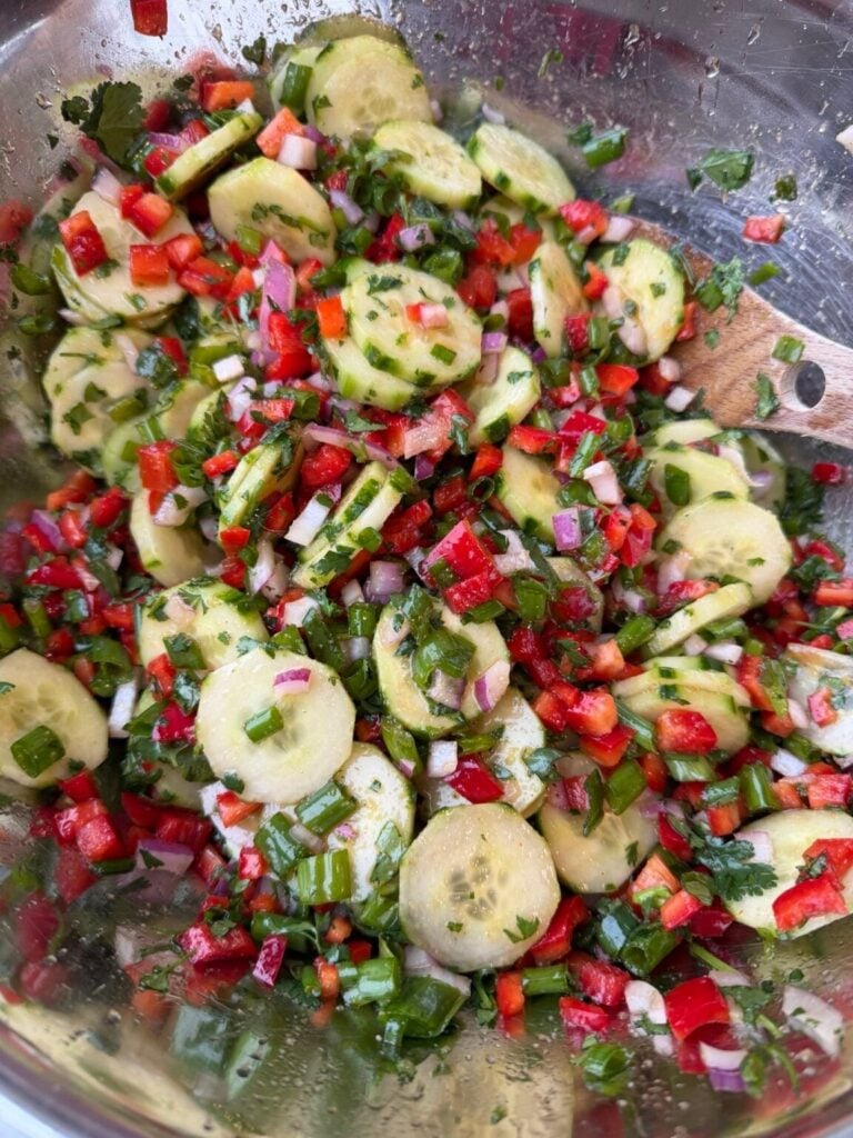 sliced cucumbers with diced peppers in a Thai dressing