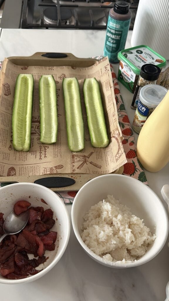 Four stripped cucumber halves with shallow channels scooped from their centers.