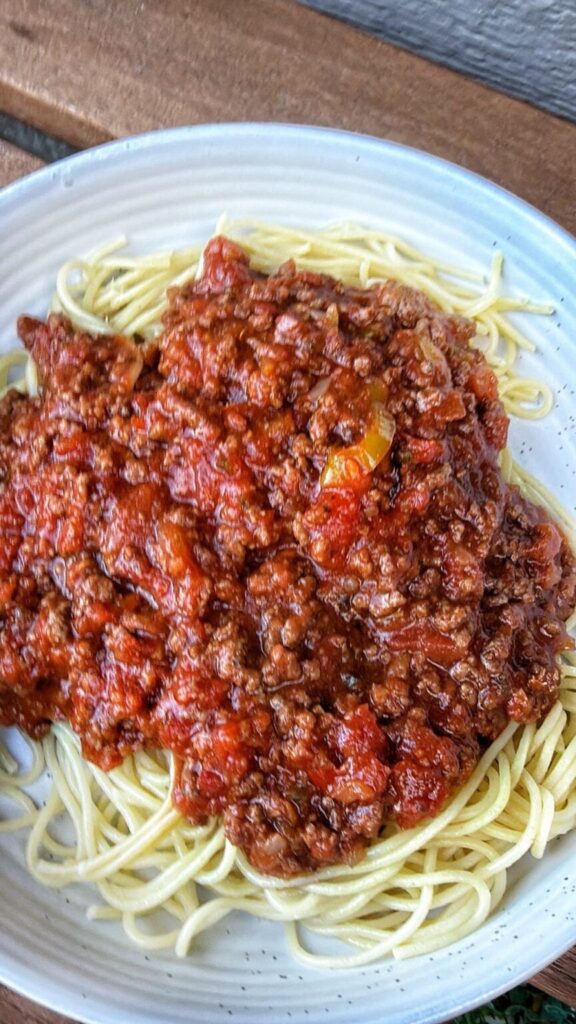 Bowl of Chicago style meat sauce on top of spaghetti