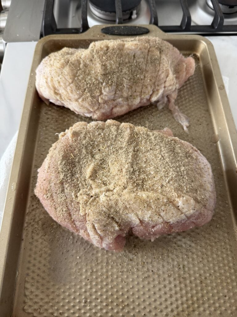 Thawed boneless turkey breast roasts rubbed with oil and seasoned with sage, poultry seasoning, rosemary, and black pepper.