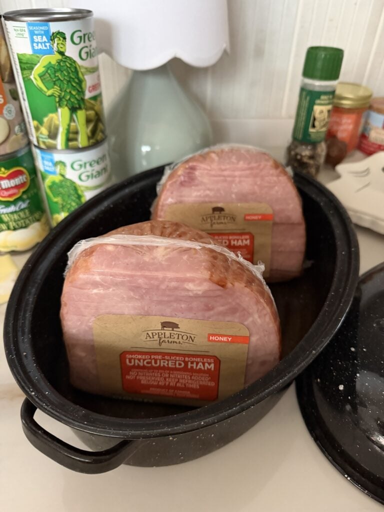 Two fully cooked mini hams with slices kept together in their original shape.