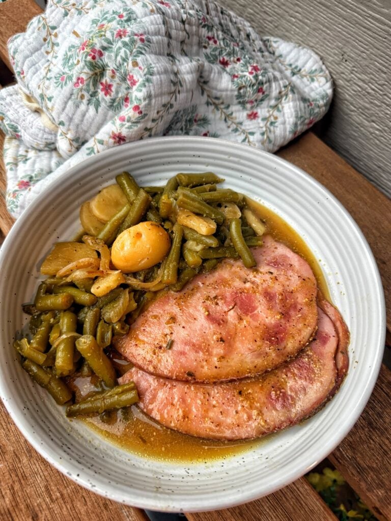 Sliced mini ham served with canned potatoes and savory mustard onion sauce