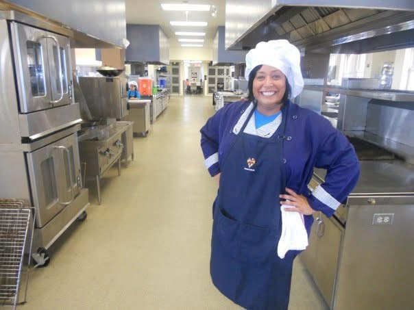 a picture of april lee wiencek in a kitchen in chef wear 