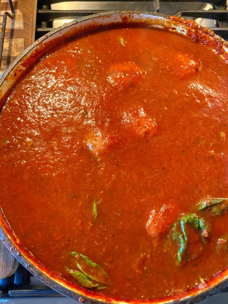 Pot of Sunday sauce tomato sauce with basil pieces