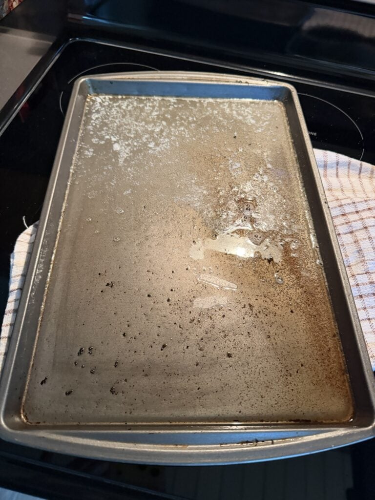Empty rimmed metal baking sheet used to make the hash brown and egg bake.