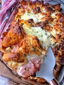 A casserole baked with croissants, ham and cheese